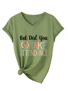 Close-up detail of the green V-neck short sleeve tee featuring graphic text chest print.
