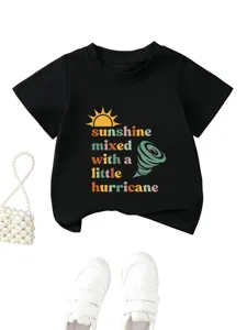 Close-up detail of the graphic print and soft black fabric on the children's t-shirt.