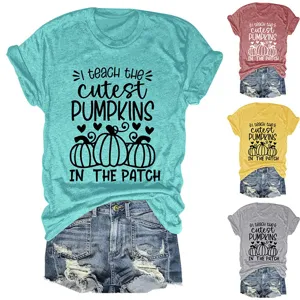 Detail shot of women's short sleeve graphic tee with cute pumpkin print and denim shorts.