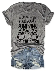 Close-up detail of women's grey short sleeve t-shirt featuring cute pumpkin graphics.