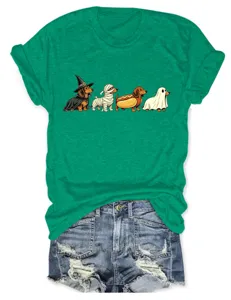 Close up view of green short sleeve t-shirt featuring cute halloween dachshund dogs graphic print.