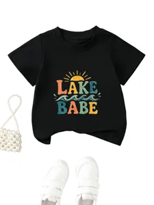 Detailed view of the black cotton children t-shirt featuring colorful lake babe graphic print.