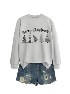 Detailed view of the stylish Christmas themed long sleeve sweatshirt paired with denim shorts.