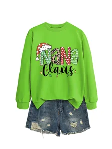 Women's green Christmas graphic sweatshirt paired with distressed denim shorts for holiday casual wear.