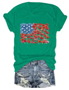 Detailed view of the vibrant floral flag graphic on the green cotton t-shirt with denim shorts.
