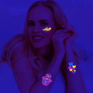 Glow in the dark temporary face and arm tattoo stickers, waterproof fluorescent festival body art.