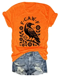 Detail view of the orange short-sleeve t-shirt featuring a retro crow and floral graphic print.