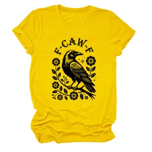 Close-up detail of the yellow short-sleeve t-shirt featuring a black crow and floral graphic.
