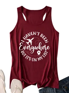 Close-up detail of the maroon racerback tank top featuring travel quote white print.