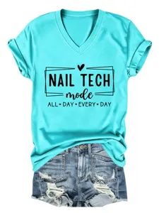 Close-up detail view of the vibrant turquoise V-neck short sleeve t-shirt with nail tech graphic print.