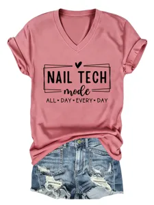Close-up detail of the pink V-neck t-shirt with nail tech graphic, paired with stylish denim shorts.