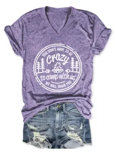 Purple V-neck short sleeve graphic tee featuring a camp theme print and styled with denim shorts.
