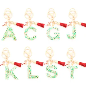 Christmas resin alphabet keychain with red tassel and candy cane charm for holiday gifts.