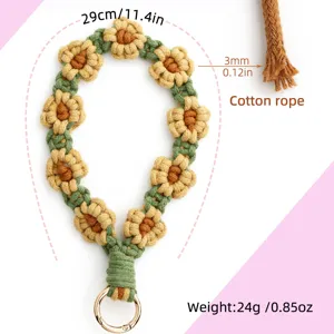 Detailed close-up view of handmade daisy macrame wristlet strap, highlighting intricate floral weaving.