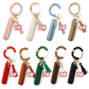 Silicone bead wristlet keychain set with leather lipstick pouch and tassel charm.