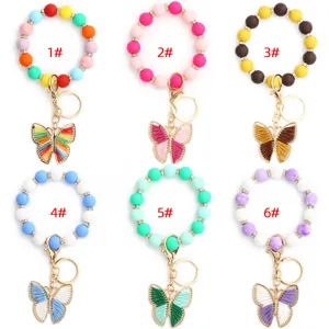 Llavero de pulsera de cuentas de silicona colorida con dije de mariposa de moda.