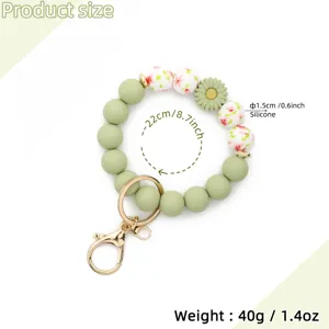 Silicone beaded keychain bracelet with floral print and daisy charm, 22cm perimeter size.