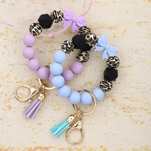 Silicone bead keychain bracelet with bow leopard print and tassel stylish bag pendant.