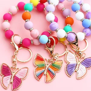 Pulsera llavero de cuentas de silicona coloridas con dije de mariposa de hilo
