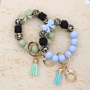 Silicone beaded keychain bracelet detail showing leopard print beads and cute bow pendants.