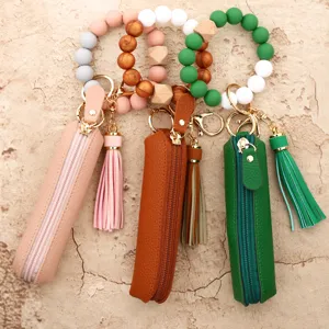 Silicone bead wristlet keychain with leather zipper pouch tassel. Detail view showing texture.