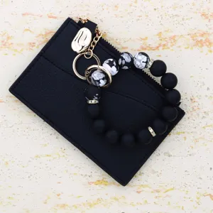 Black leather card holder wallet with silicone beaded wristlet keychain, practical daily accessory.