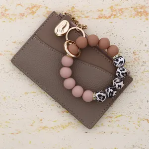 Brown leather card holder wallet with chic silicone beaded wristlet keychain for women daily use.