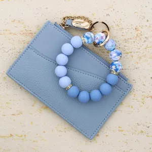 Light blue leather card holder zipper wallet with floral silicone bead wristlet detail