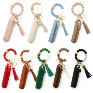 Colorful silicone beaded wristlet keychain with leather lipstick pouch and tassel charm set.