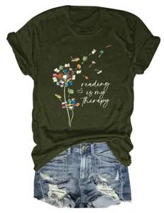 Close-up detail of the olive green graphic t-shirt featuring a book dandelion print.