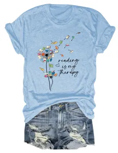 Detail view of light blue short sleeve t-shirt featuring a cute reading book graphic design.