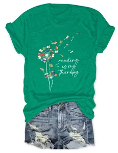 Women casual green short sleeve t-shirt featuring a cute book dandelion graphic design.