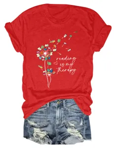 Casual red short sleeve T-shirt with book dandelion print and inspiring reading graphic.