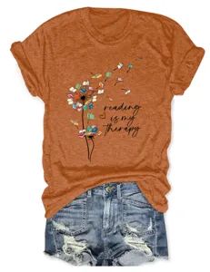 Casual women orange short sleeve graphic T-shirt paired with stylish denim shorts.