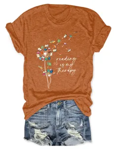 Casual orange short sleeve women t-shirt with book dandelion graphic and text print style.
