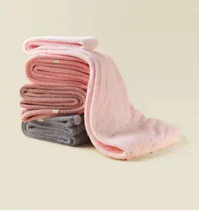 Microfiber dry hair cap detail showing soft texture, absorbent fabric, and convenient button.
