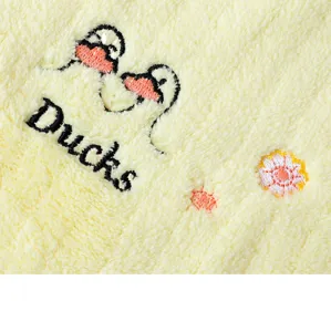 Detailed view of soft cotton children face towel with cute duck embroidery design and plush texture.