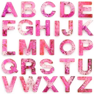 Pink glitter resin alphabet letters detail view, sparkly epoxy DIY keychain accessory set.