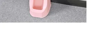 Pink plastic toilet brush holder detail, compact bathroom cleaning tool base part.