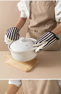 Kitchen heat resistant oven mitts with blue and white stripes for safe baking and cooking.