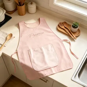 Pink kitchen apron with large pocket, waterproof and oil-proof cooking bib for home use.