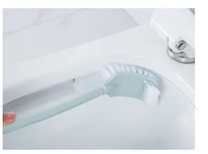 Long handle toilet brush detail showing deep rim cleaning with white bristles in bathroom.