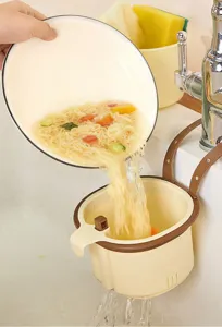 Detailed view of kitchen sink hanging drain basket filtering food waste efficiently.