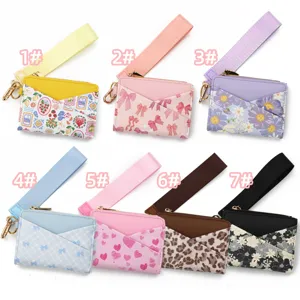 Leather card holder wallet with wrist strap and keychain for women, assorted printed designs.