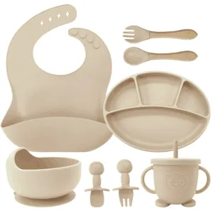 Details of baby silicone feeding set including divided plate, bowl, bib, cup, and spoons.