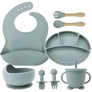 Complete baby silicone tableware set including divided plate bowl bib and fork spoon for kids.