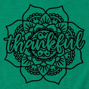 Closeup detail of women's green t-shirt with black mandala flower and thankful graphic print.