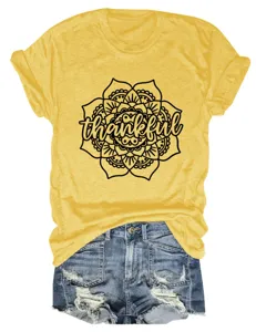 Close-up detail of women yellow short sleeve t-shirt with thankful mandala print graphic.