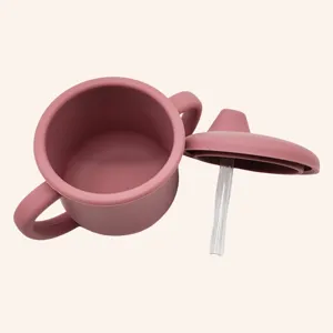 Silicone baby sippy cup detail, twin handles and straw, soft mauve color, safe toddler drinkware.