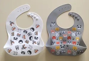 Waterproof silicone baby bib with pocket and cute cartoon animal prints, adjustable size.